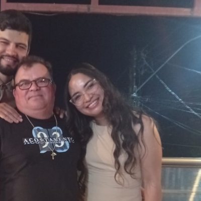 Ana Paula beside her father and brother at his 70th birthday party