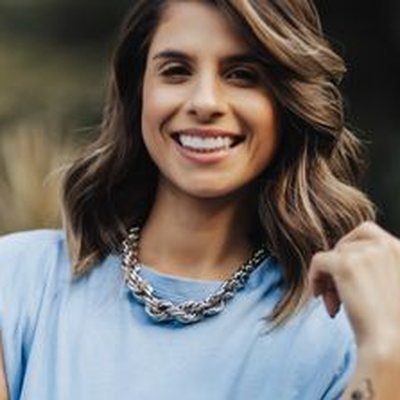 Beatriz smiling, photographed outdoors